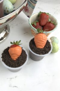 These adorable Carrot Patch Dirt Cups are perfect for spring and easy to make using store bought pudding cups, topped with crumbled chocolate sandwich cookies, and chocolate-covered strawberry “carrots”.  