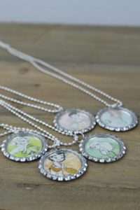 These fun and easy bottle cap necklaces are a great DIY craft for fish extender or pixie dust gifts for your next Disney Cruise.