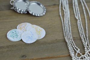 These fun and easy bottle cap necklaces are a great DIY craft for fish extender or pixie dust gifts for your next Disney Cruise.