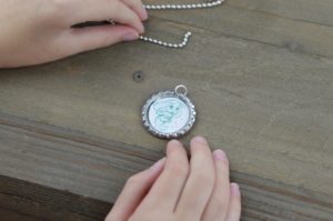 These fun and easy bottle cap necklaces are a great DIY craft for fish extender or pixie dust gifts for your next Disney Cruise.