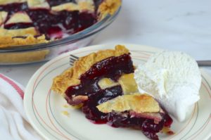 This easy and delicious cherry pie has a flaky crust that is filled with homemade cherry pie filling.  It is bursting with cherry flavor that's both sweet and tart. 