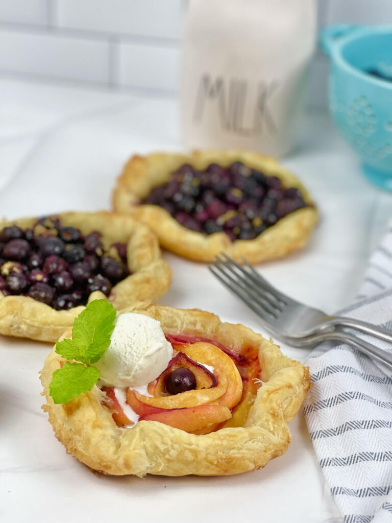 Gorgeous mini peach blueberry galettes are the perfect, fun, and simple dessert with seasonal fruit.