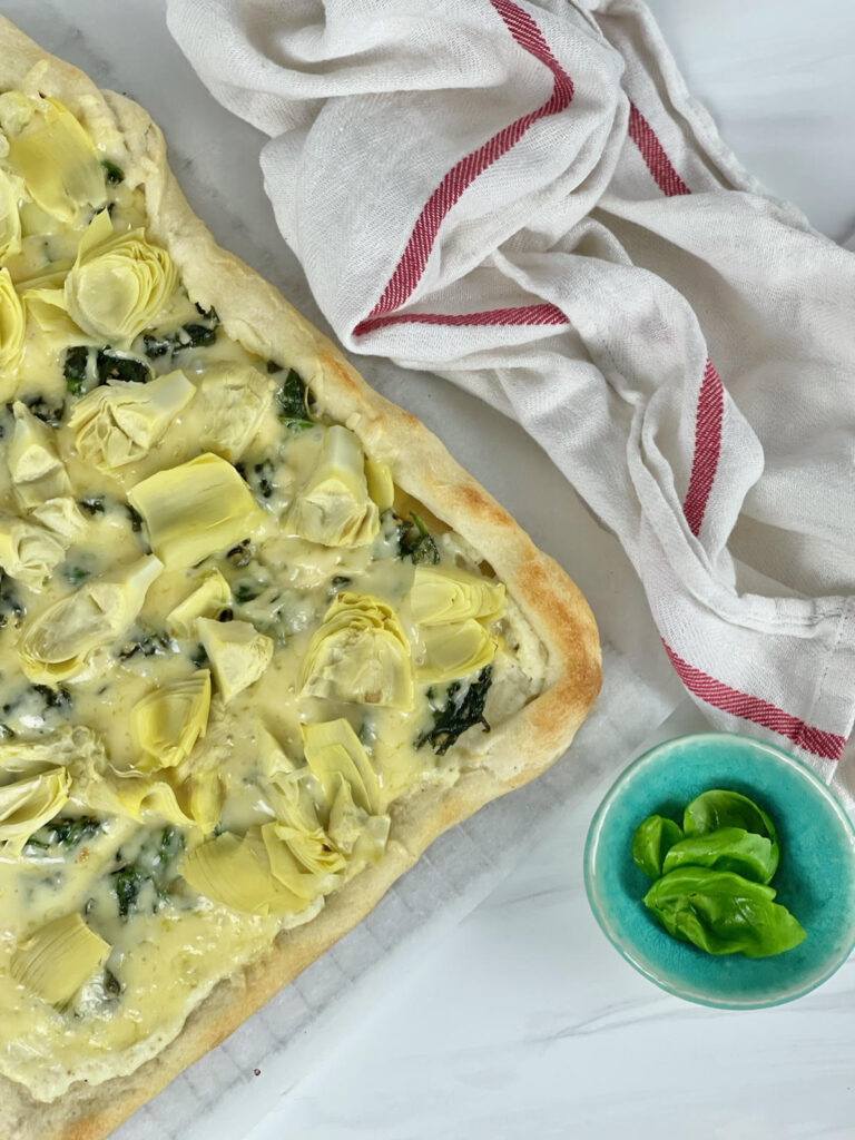 This cheesy, vegetable-filled Spinach Artichoke Pizza is an easy weeknight meal that the whole family will love.