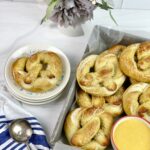 These soft and delicious homemade pretzels with a creamy beer cheese dipping sauce are easy to make and perfect for get-togethers. 