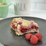 These Raspberry Crumble Bars combine the tart flavors of raspberries with a buttery base and delicious crumble topping. Making these rich buttery raspberry-filled bars takes very little time and only a few ingredients.