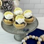 These Lemon Blueberry Poke Cupcakes are easy to make using a boxed cake mix combined with a homemade lemon blueberry sauce and homemade whipped topping.