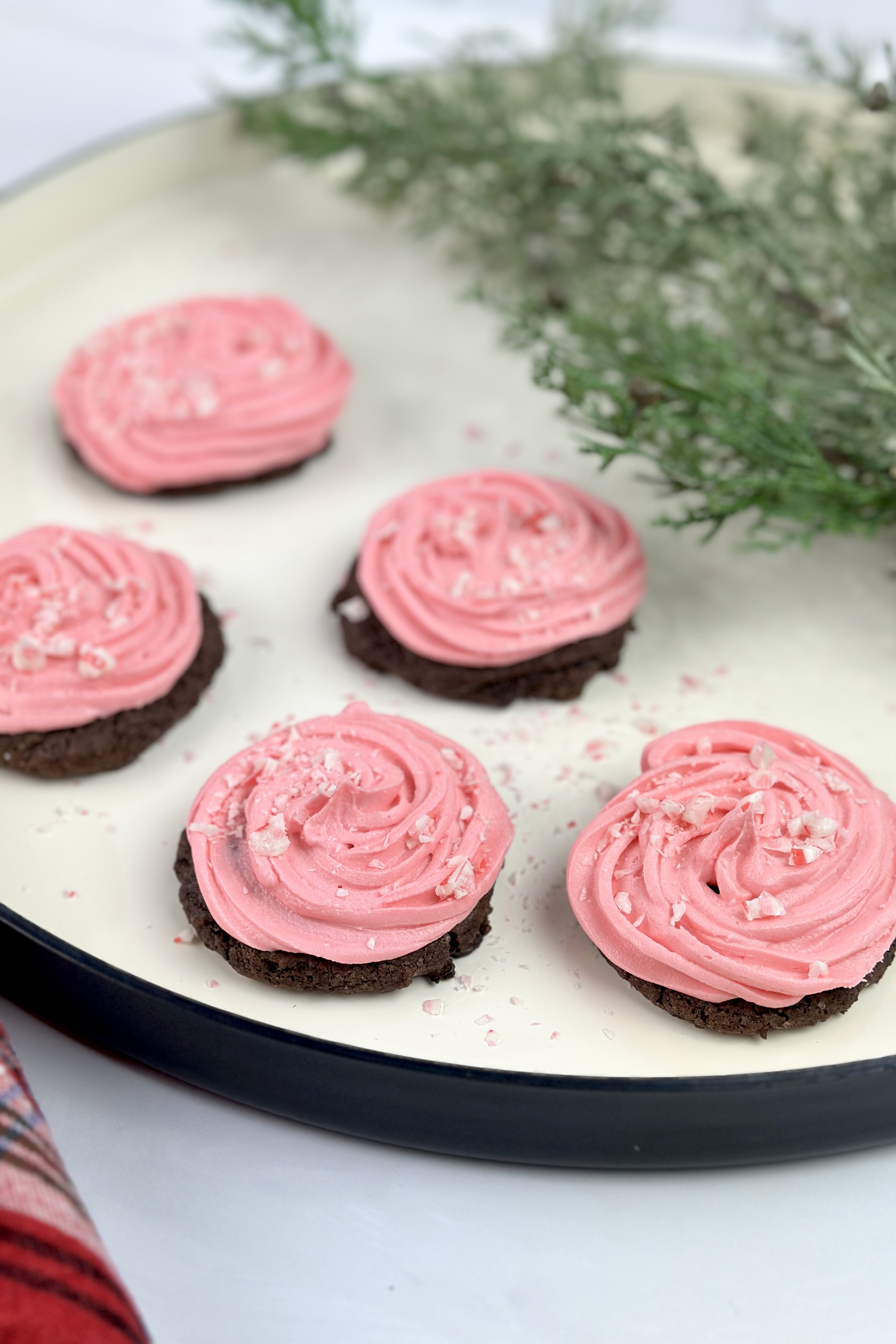 These decadent chocolate cookies and creamy peppermint frosting are the perfect combination of peppermint chocolate cookies perfect for this holiday season.