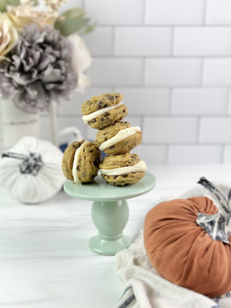 Soft and chewy pumpkin chocolate chip sandwich cookies stuffed with cream cheese frosting are a must-try this fall!